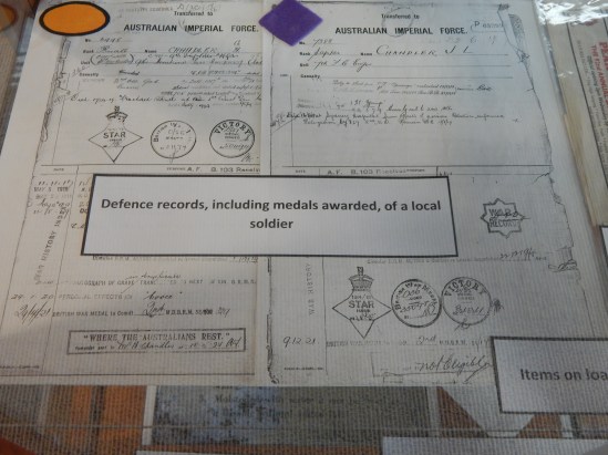 War Service records of a soldier from the local area, which include the colours attached to uniform and the stamps of medals awarded. Item on loan courtesy of Parkes Historical Society.