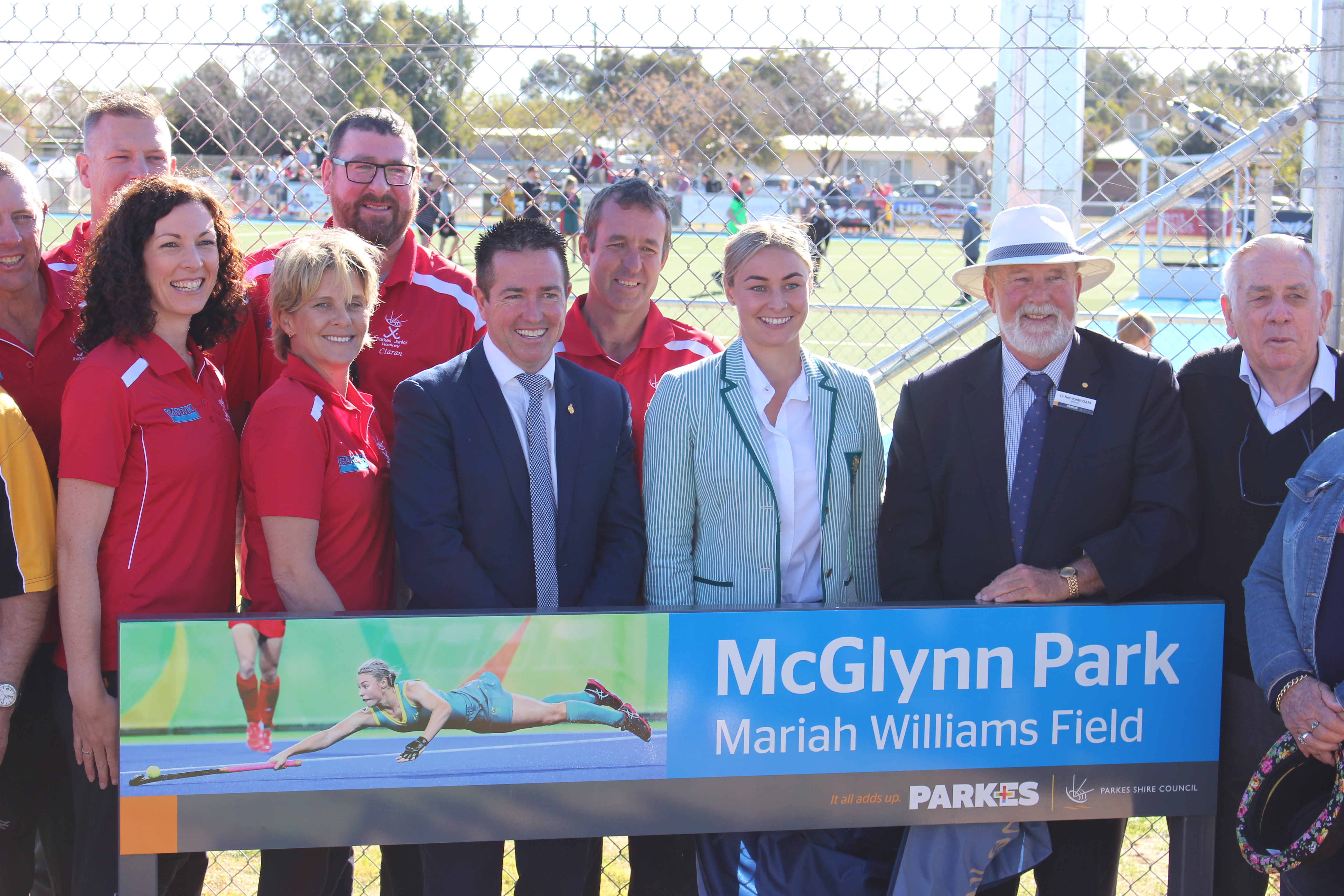 Photograph from the Official Opening of the Mariah Williams Field at McGlynn Park. Mariah Williams is seen with Minister for Racing Paul Toole and Cr Ken Keith OAM, Mayor of Parkes Shire along with members of the community and Parkes Hockey Inc. Photograph from Parkes Shire Council Media Release, taken August 26th, 2017