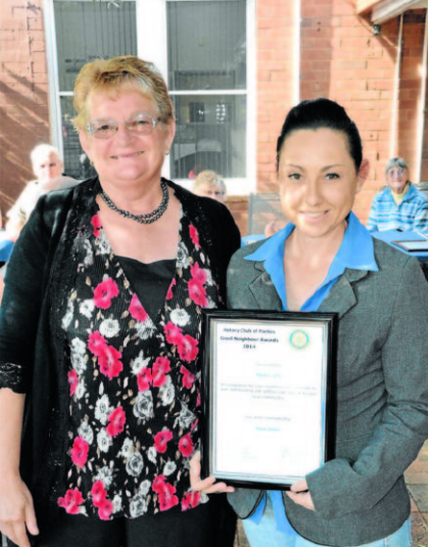 Rose Jones (left) nominated Parkes SES as her Good Neighbours. The nomination was collected by SES member, Amanda Corcoran. Source: Parkes Champion Post 18 May 2014