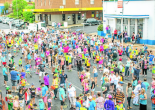 This photograph was taken from the first floor of Parkes Leagues Club looking onto the attempt at the record for most people hitting a tennis ball on a racquet at one time. Parkes now holds the record with 772 people taking part, many coming from all over the Parkes Shire. The building in white and blue is the clock tower building, and everyone assembled is on Clarinda Street. The cross street is Browne Street. This photograph was taken by Hank Paul on Saturday November 16, 2013. Source: Parkes Champion Post http://www.parkeschampionpost.com.au/story/1914815/gallery-ao-blitz-roadshow/#slide=8