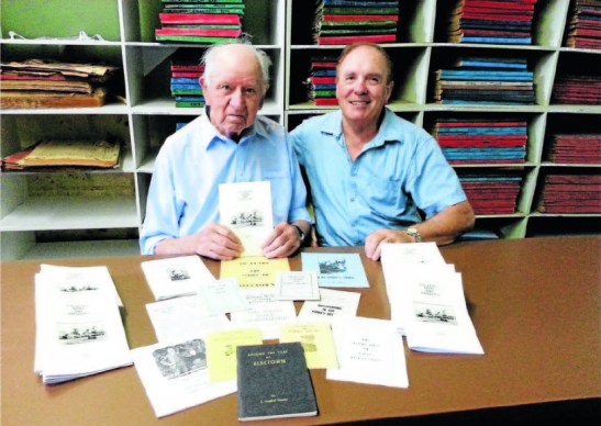 Len (at age 97 years old) in 2014 with nephew Don Unger and some of the books that he had researched and published. Photo: Parkes Champion Post website