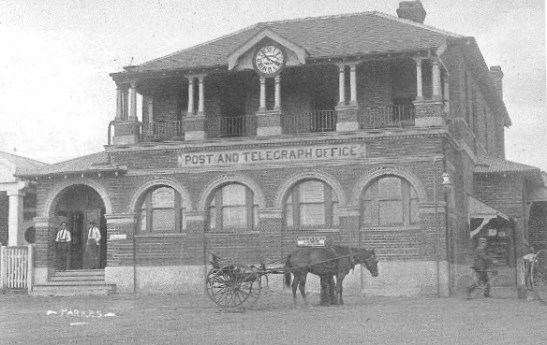 Another photograph from Ian Chambers' collection. A photograph of Parkes Post Office in the 1910s. The inscription in the book reads: The Post Office is probably the most photographed building in Parkes, with its many alterations, extensions and face-lifts faithfully recorded by the camera. This picture was used as a postcard, and the men on the steps, the horse and buggy, and the man with the bicycle add interest to the scene. Note the gas lamp at the corner of the building and the absence of formed footpaths and gutters. The clock was installed by local watchmaker A.G.F. Bollinger in 1895 at a cost of £30. Source: Parkes: A Photographic History by Ian Chambers 1988 oage 109