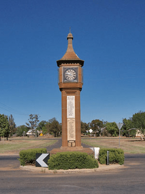 Photograph of the War Memorial Clock Tower. The square clock tower built of sandstone with plaques attached. Since 2007 the original stone plaques have been replaced with brass ones. Source: War Memorial Register website