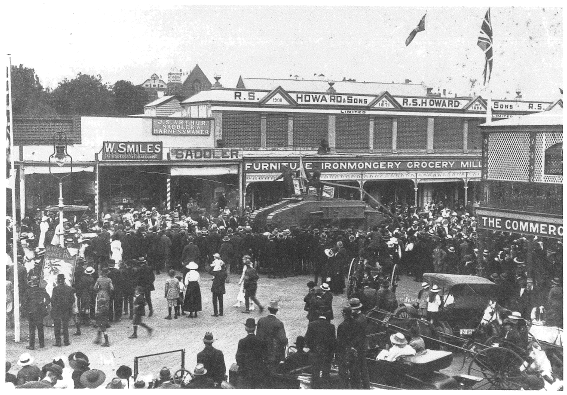 This photograph from Ian Chambers' book is the one that John Howard remembers with Wally Smiles being the hairdresser adjacent to Howards stores. The photograph documents a fundraising endeavour during First World War. This rally was held in the Square (where Henry Parkes statue is located) on Saturday 5th October 1918. Source: Chambers, Ian (1988) p.124